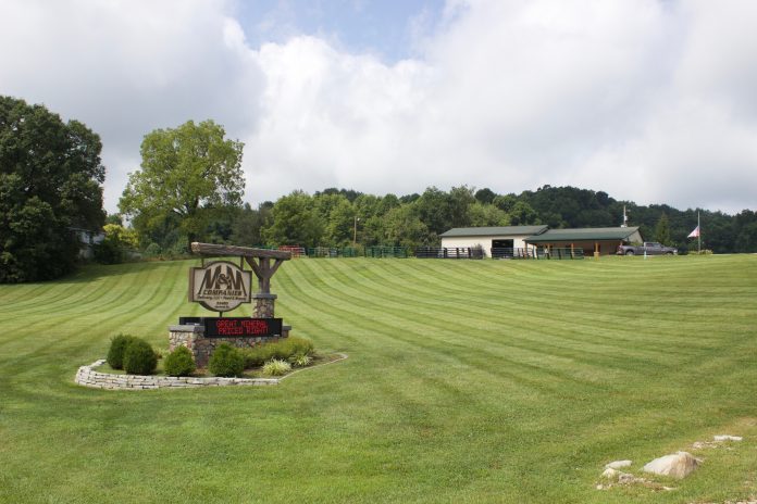 M&M Feed Supply A sign for M&M Feed Supply with the store behind it.