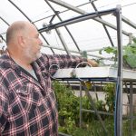Cleveland-born veteran finds peace, community in W.Va. farming David Clough looks at a plant he grew hydroponically in his greenhouse.