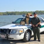 ODNR officer died in line of duty An ODNR officer and K-9 stand in front of a car.