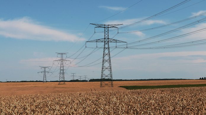 High Tension Power Lines Over Field