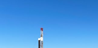 an unconventional oil and gas drilling rig sits in a green field in eastern Ohio