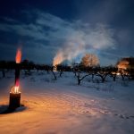 Fruit farmers assess damage from warm early spring, late freeze Fires lit in a snow-covered peach orchard.