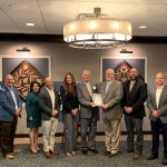 Encino Energy wins award for excellence people standing in a row accepting an award