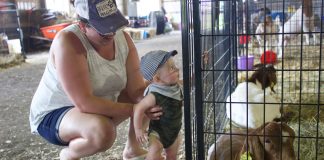 Fairgoers embrace traditions, try new things at Summit Co. Fair A woman and a child stand next to a goat pen at the fair.