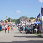 Fairgoers walk around at the Canfield Fair.