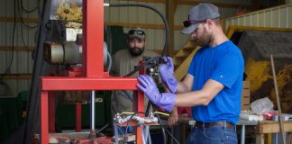 Fitch Pharm Farm relies on farmer mentors to diversify Two men demonstrate how a cider press works.