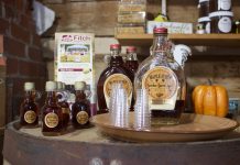 Maple Syrup Producers of NE Ohio to host workshops Bottles of maple syrup and small glasses set up for sampling on a table in a store.