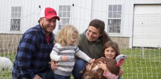 A couple and their two daughters with a turkey.