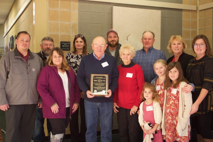 A family poses together after receiving an award.