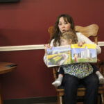 Annual Ag Literacy Week connects Pennsylvania farmers and children a woman reads a book to a group of people with a daughter on her lap