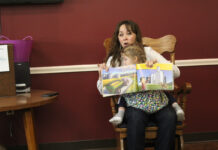 Annual Ag Literacy Week connects Pennsylvania farmers and children a woman reads a book to a group of people with a daughter on her lap