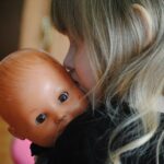 Playing pretend is serious business little girl with baby doll