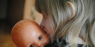 Playing pretend is serious business little girl with baby doll