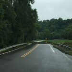 How flood plain management affects you flooding over a road