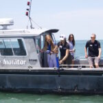 Researchers forecast mild algal bloom for Lake Erie Researchers take water samples from a boat in Lake Erie