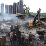 Is your dairy prepared for a disaster? men watch an excavator dig in remains of a barn fire