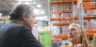 a man and a woman talk at a foodbank