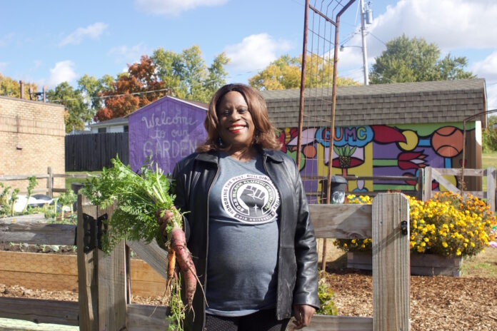 se_urban_farms_1 A woman stands in front of a garden in Columbus.