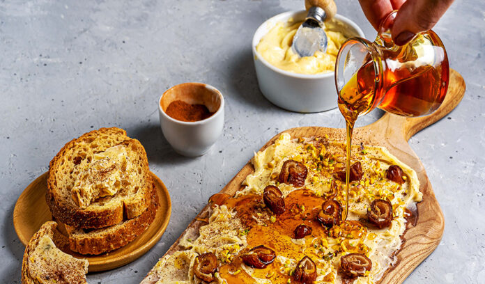 Sweet butter board is made with soft butter, honey, cinnamon, dates, and crackers. Sweet butter board