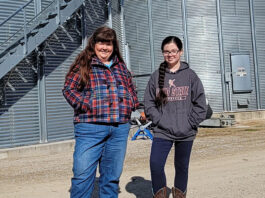 Marcia and Mae Ruff stand in front of grain containers, Feb. 11. The containers were built in partnership with Farmers Business Network.