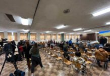 EPA expands soil testing on farms around train derailment site people sitting at chairs facing away from the camera with a floor