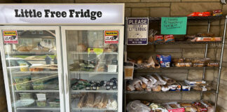 open "little free fridge" with food sits beside an open shelf of food