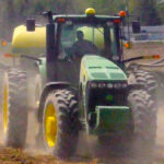 Trump administration comes to aid of farmers with $12 billion in payments tractor plowing field kicking up dust