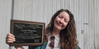 Farm and Dairy reporter wins international writing award a woman stands holding an awards plaque