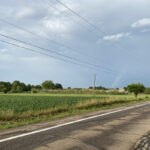 Grain prices impacted by rain, but what about crops? rainbow over cornfield