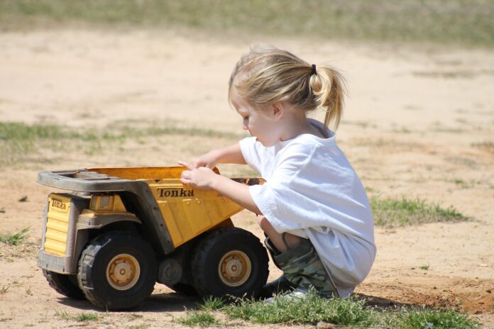 child playing in dirt