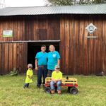 Schmuki family balances dairy farm, forestry on Ohio tree farm of the year A man, a woman and two boys stand in front of a barn.