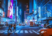 Going home to the city people walking on pedestrian lane during night time