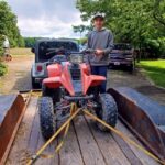 Daniel loading 4-wheeler on trailor