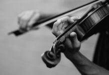 Letting life happen through you grayscale photo of person playing violin