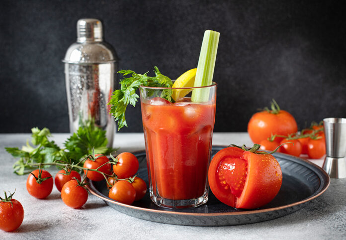 Classic alcoholic cocktail Bloody Mary with ice, lemon and celer