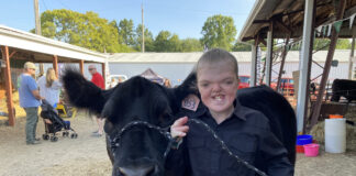 12-year-old girl with Apert syndrome shows largest steer at Portage County Fair claire and socks